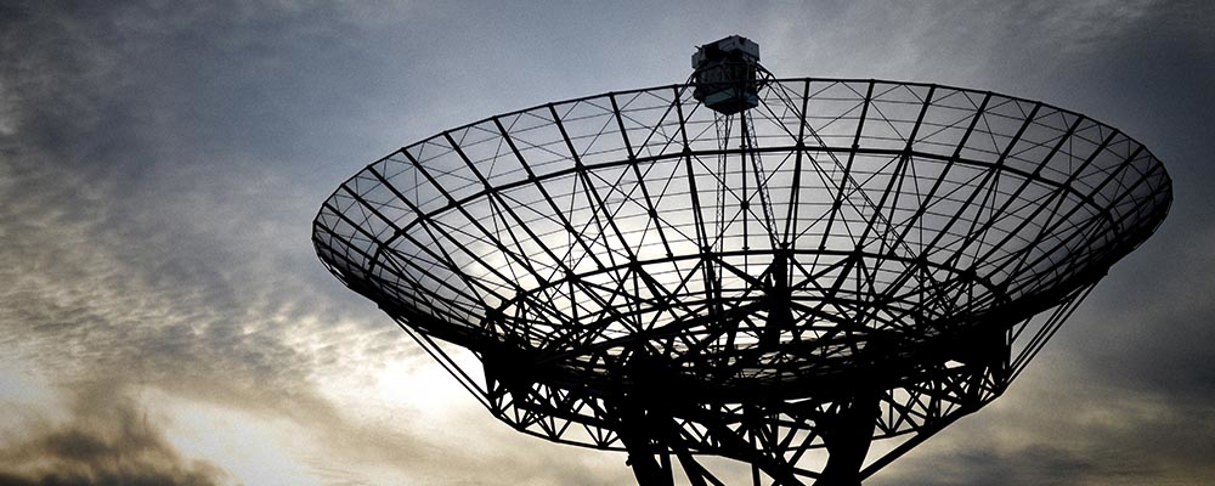 Stor parabolantenn med himmel som bakgrund