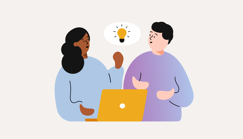 En man och en kvinna i dialog framför en bärbar dator. En glödlampa lyser ovan dem symboliserande en idé.